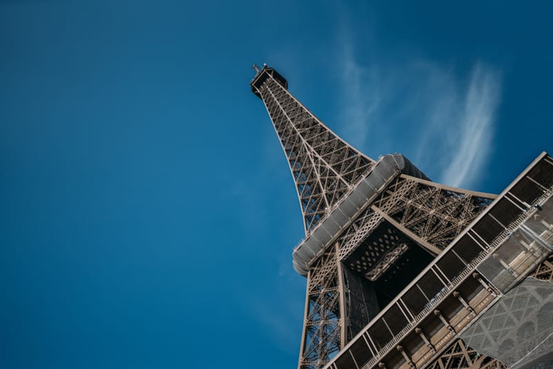 The Eiffel Tower against a clear blue daytime sky.